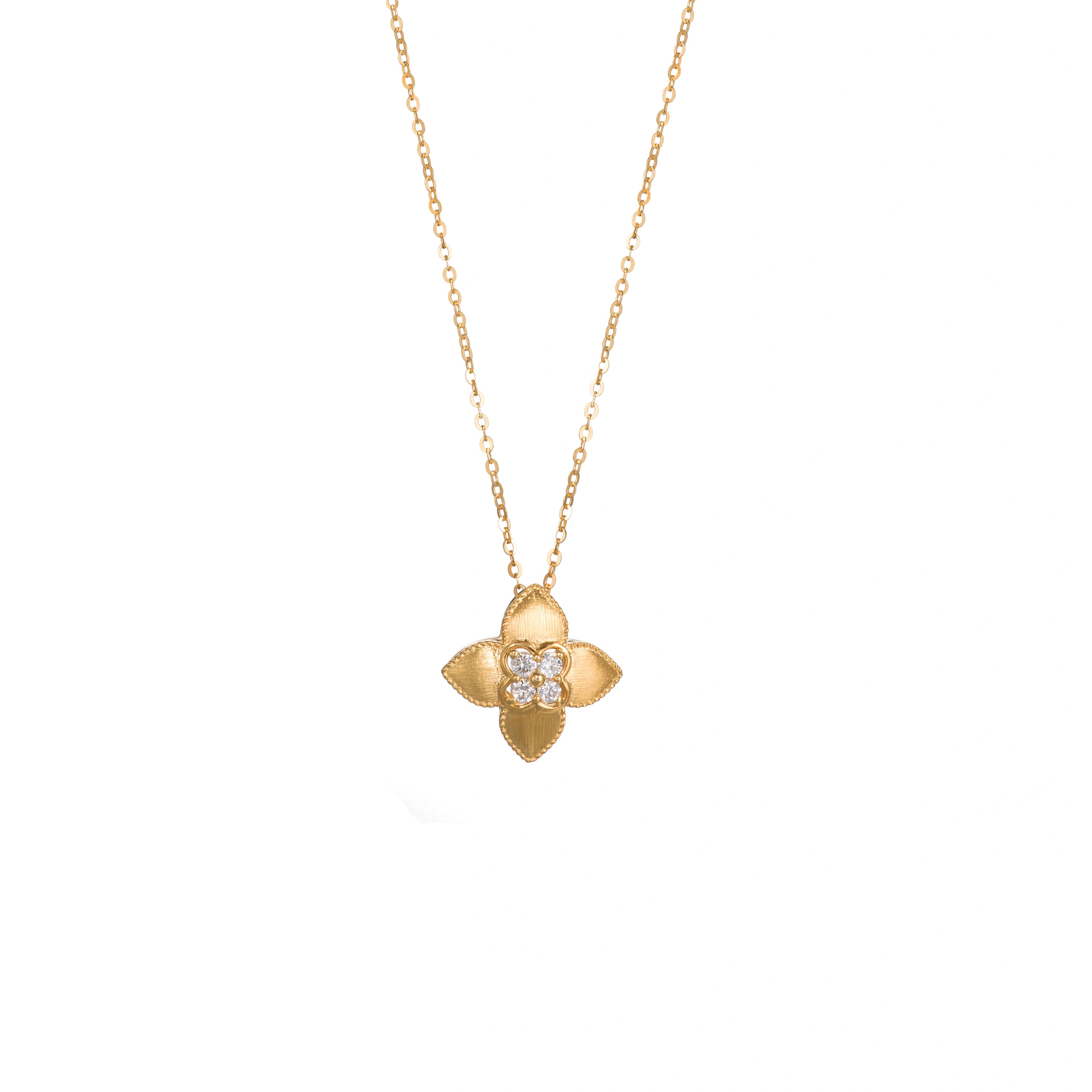 18K gold four-leaf clover diamond necklace with textured flower petals on a white background