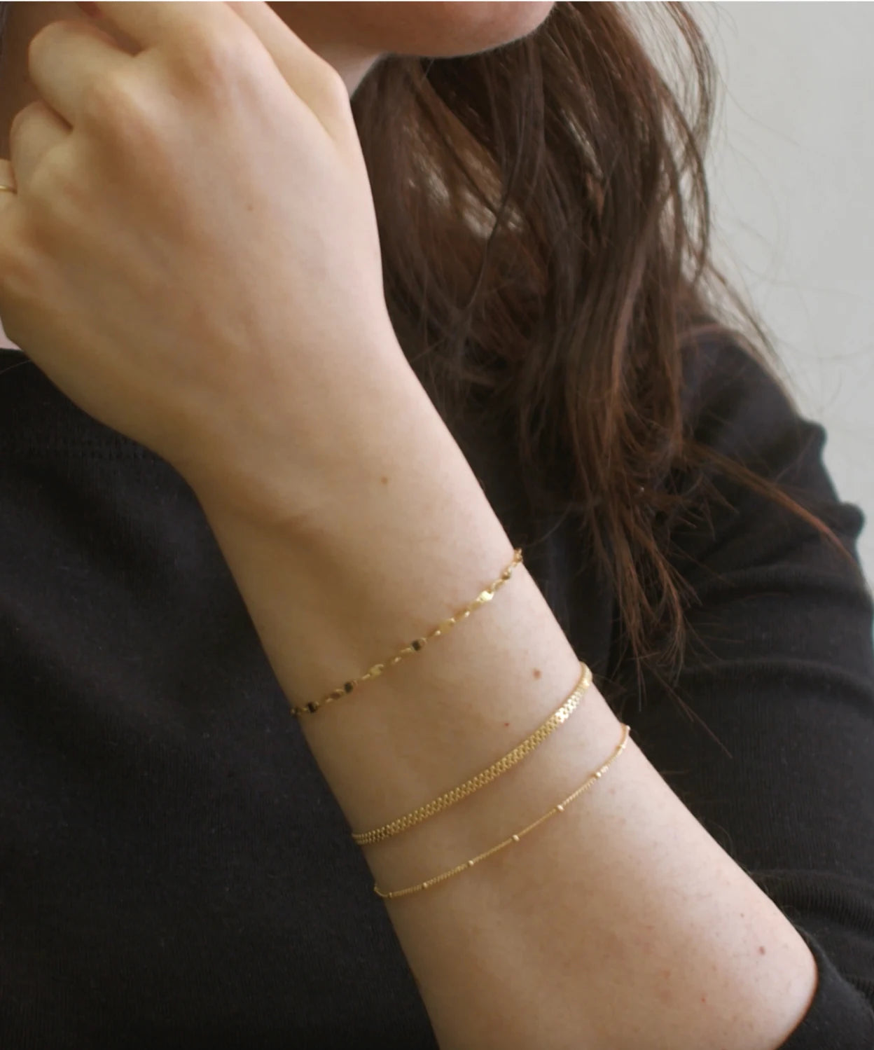 Layered gold bracelets worn by a model, showing bracelet size, fit, and everyday styling for LeMing jewelry.