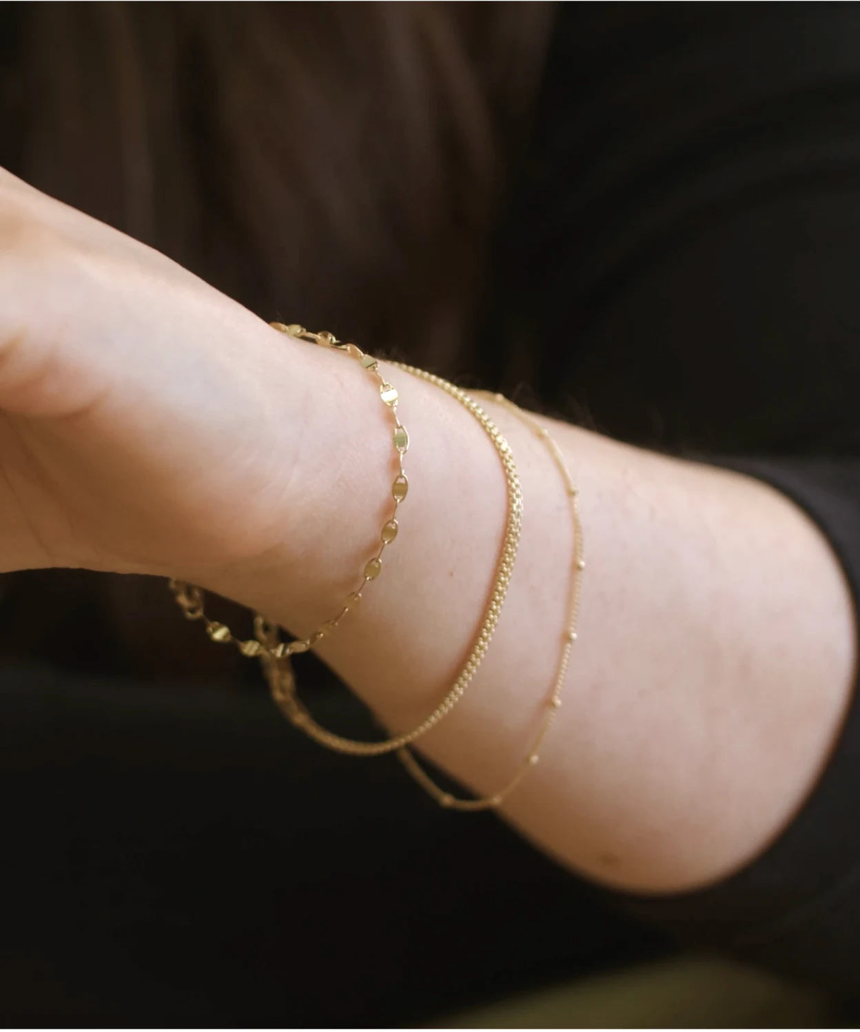 Layered gold bracelets worn on a wrist, showing bracelet fit and styling for the LeMing size guide.