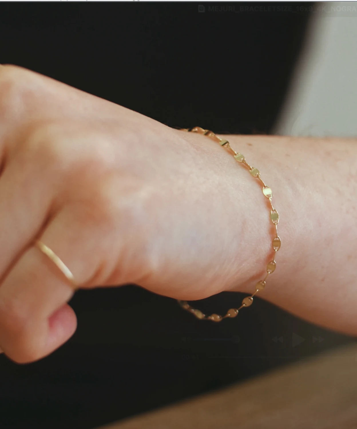 Close-up of a gold bracelet on the wrist, showing a snug bracelet fit for the LeMing size guide.