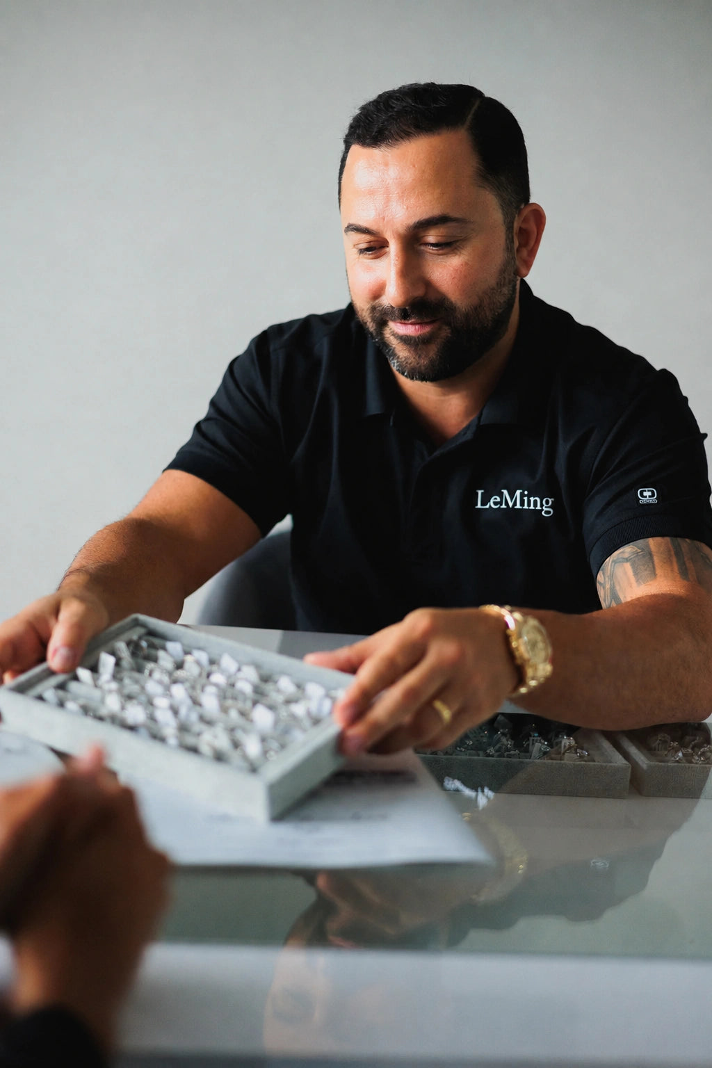 LeMing jeweler presenting a tray of fine jewelry for custom jewelry design consultation