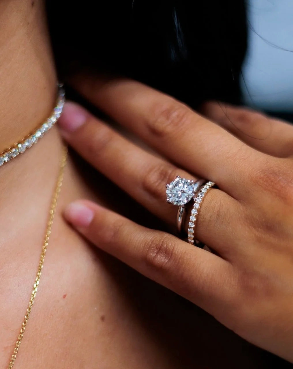 Close-up of diamond engagement rings worn on hand for LeMing diamond setting services