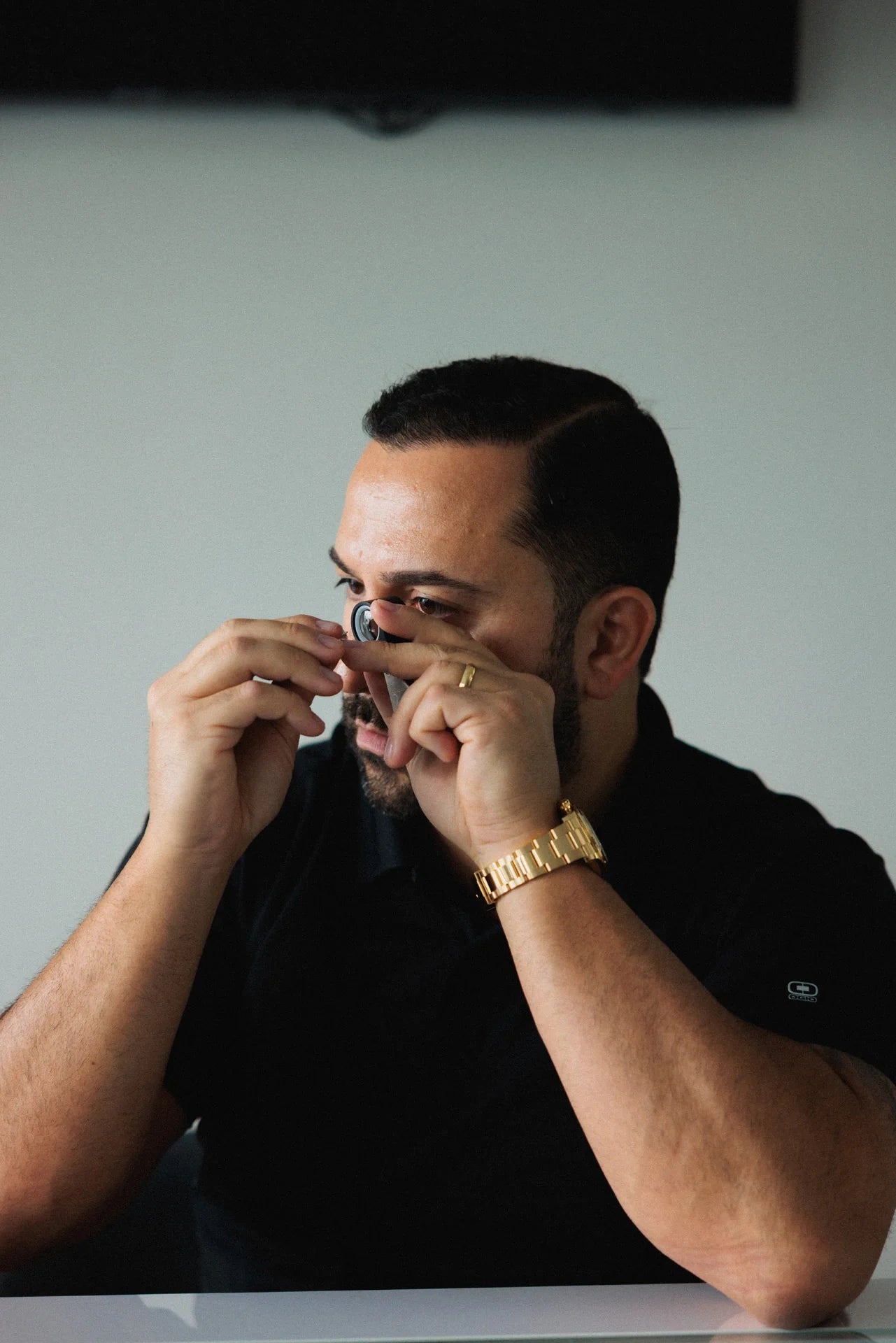 LeMing jeweler inspecting jewelry with a loupe for professional jewelry repair service