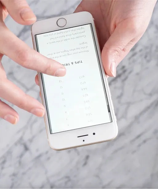 Phone displaying a ring size chart, showing how to match finger measurement to the correct LeMing ring size.