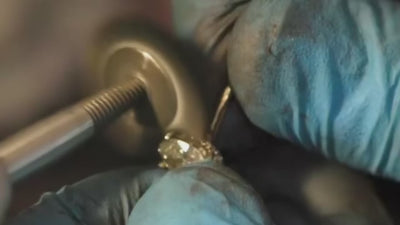 Close-up of a jeweler handling a diamond ring for LeMing custom jewelry design service